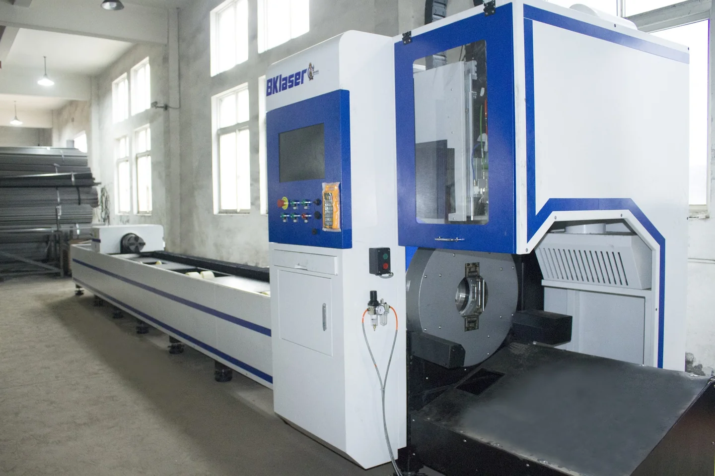 Large blue metal-processing equipment inside a manufacturing workshop