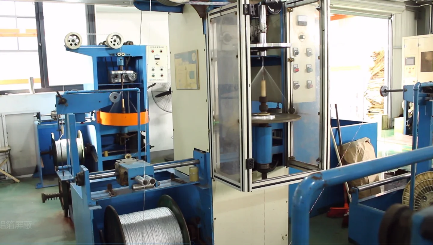 Cable-processing machinery with reels and metal shielding material
