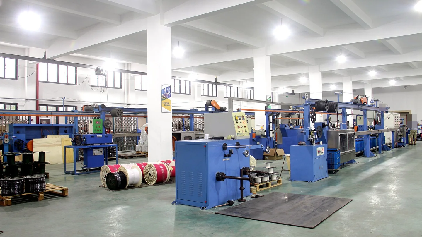 Rows of cable-processing machines inside a factory workshop